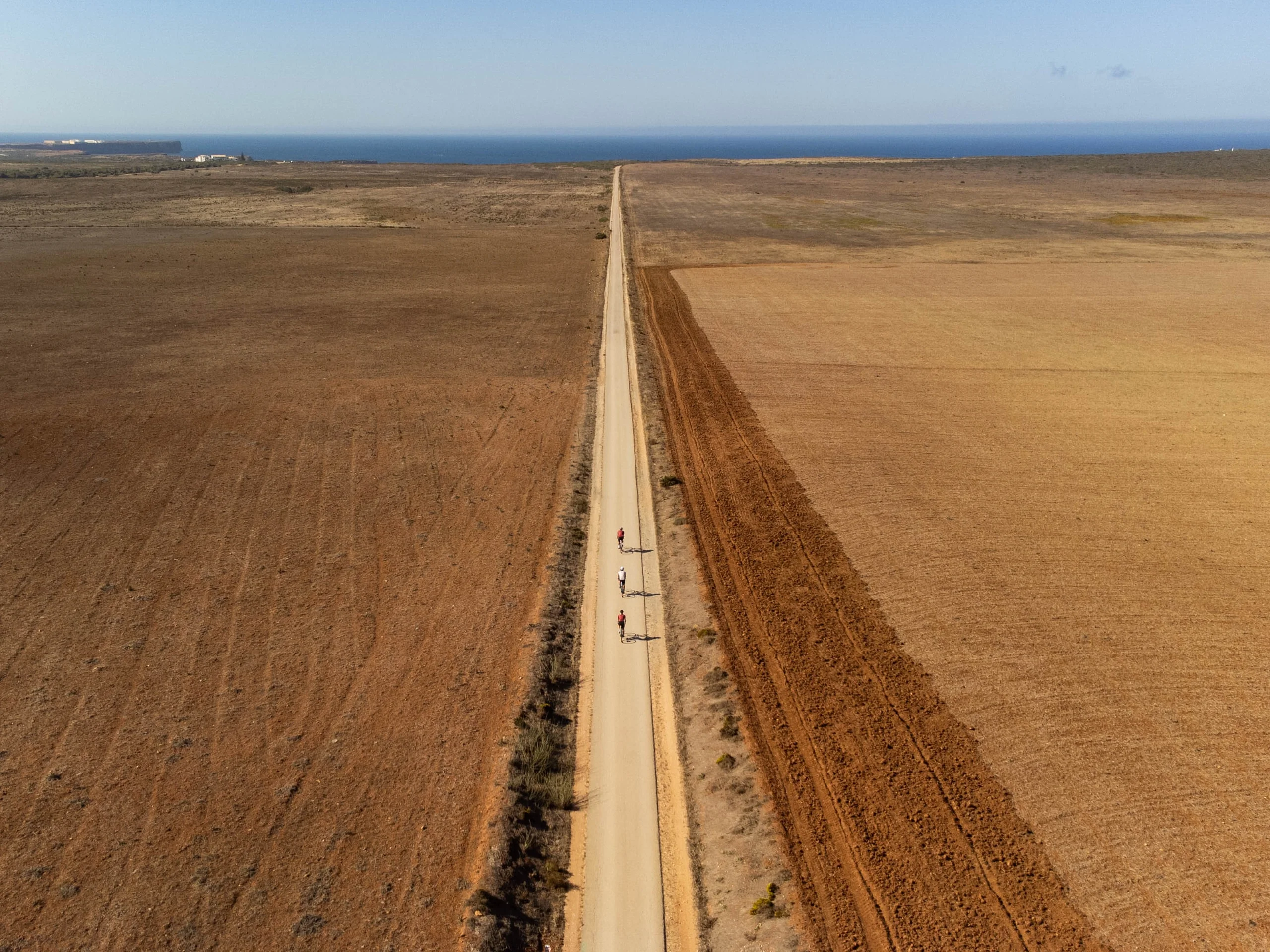 A straight road across open farmland, seen from the air