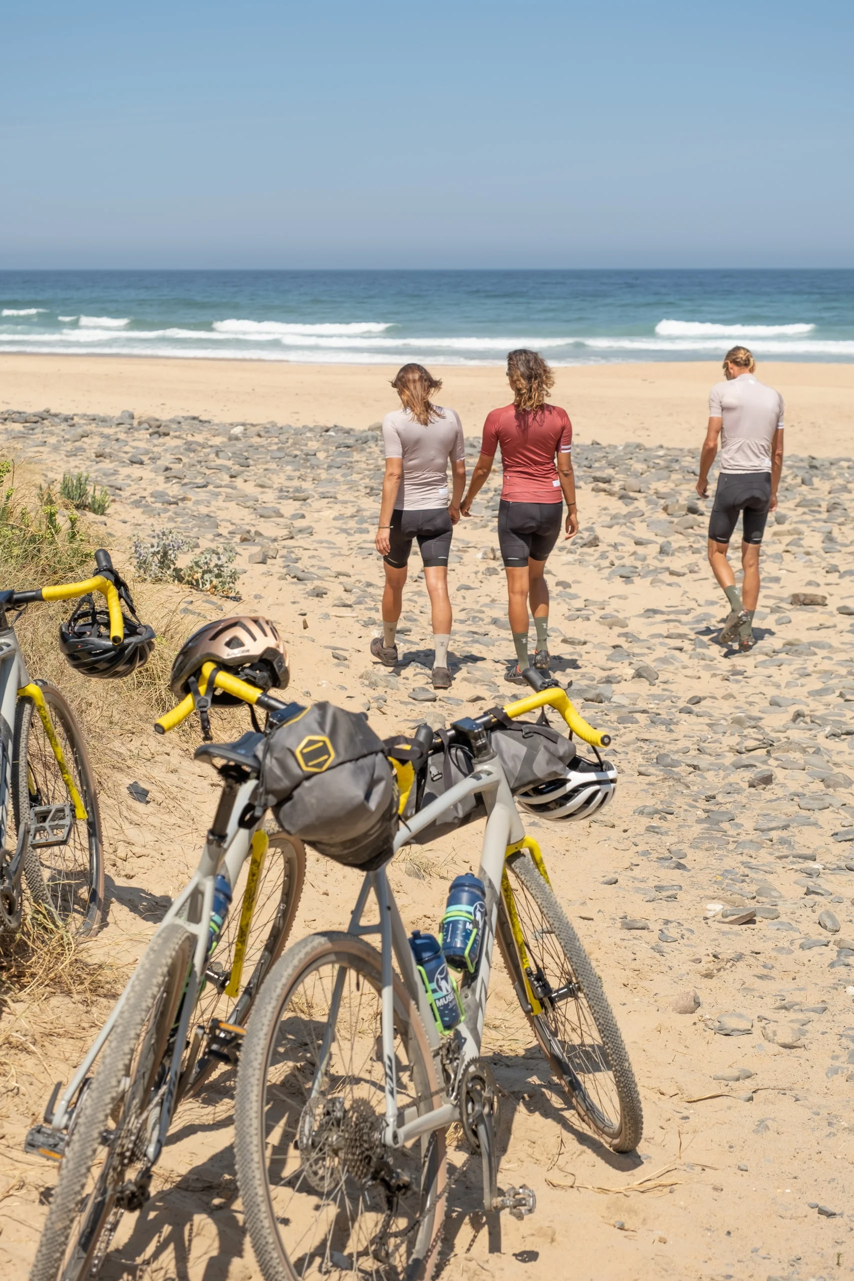 Bikes laid down on the sand at a beach on the Costa Vicentina after a ride