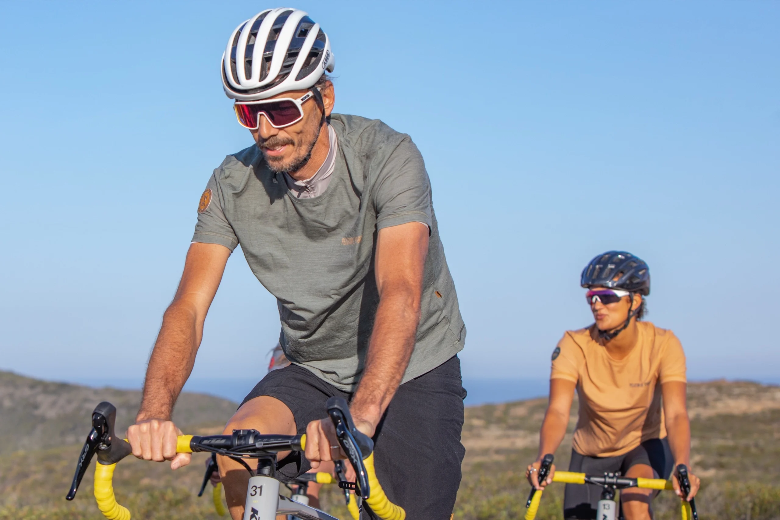 A group of cyclists riding together along the coast road in the West Algarve, the Atlantic beside them