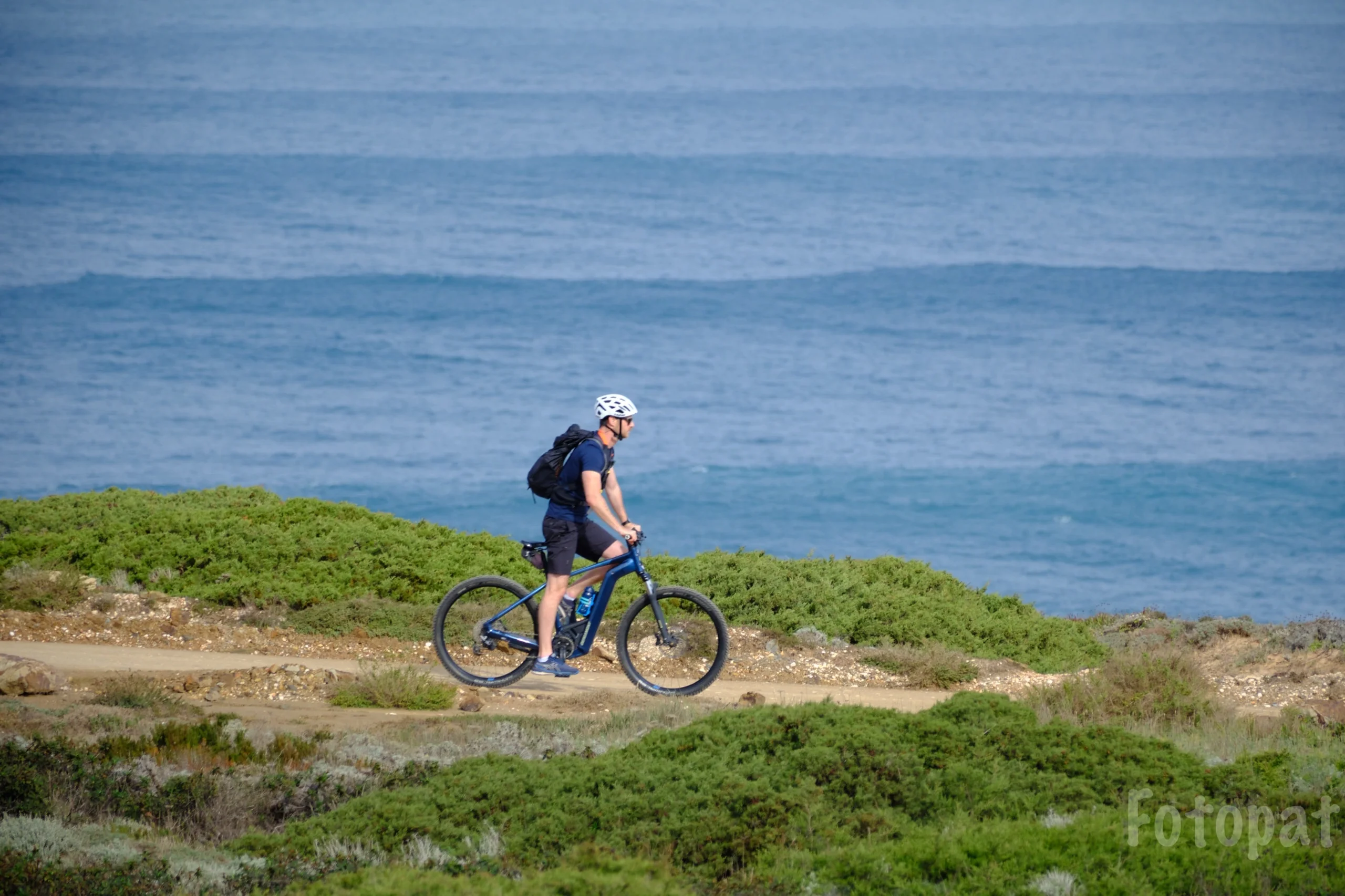An e-bike rider on the coastal path above the Atlantic