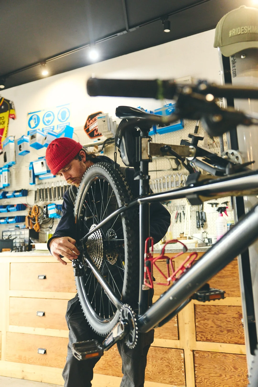Gregor, head mechanic at Musette, working on a bike in the Musette workshop in Almádena
