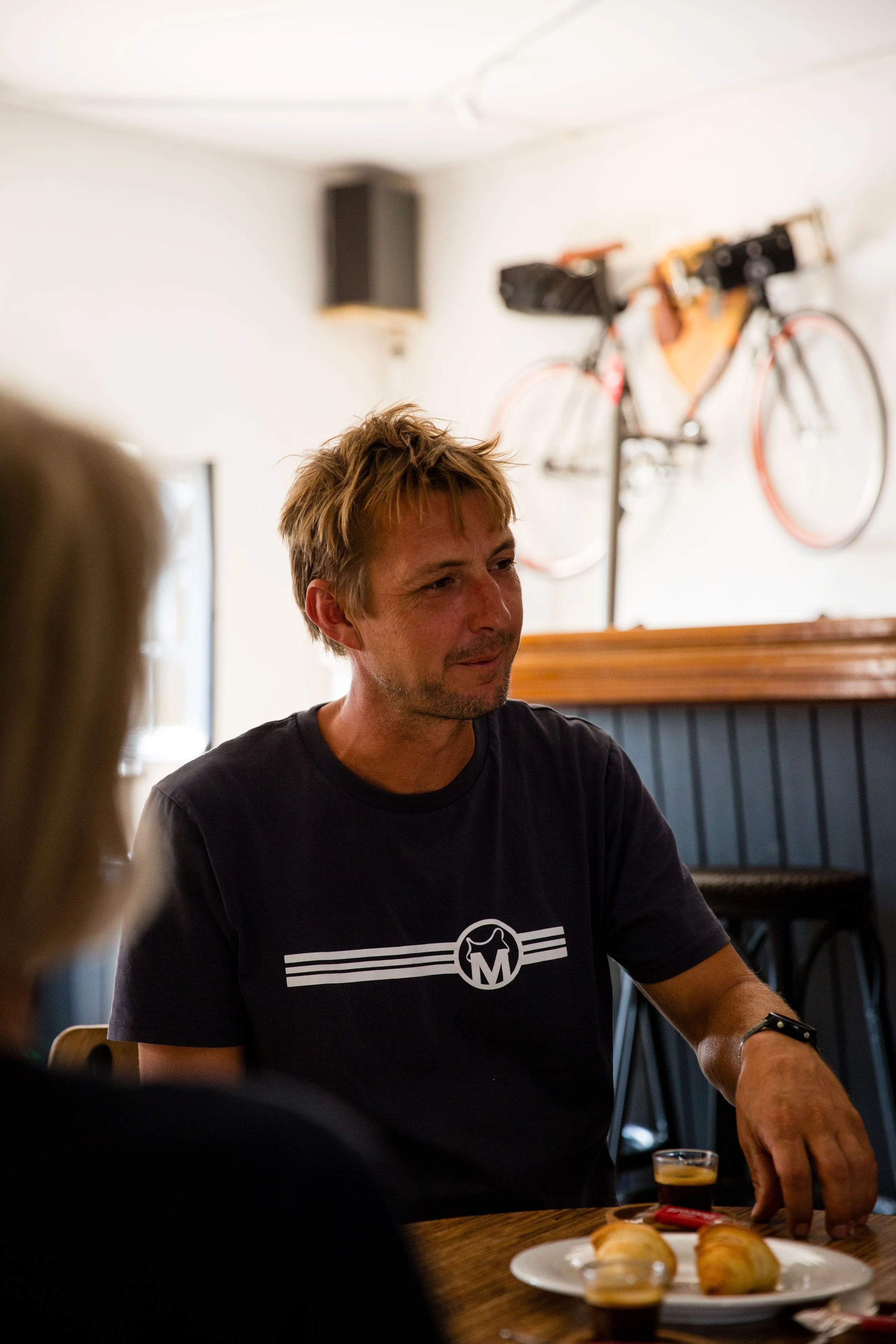 Jerom Pannier at a table in the Musette café in Almádena, the hub where every trip starts