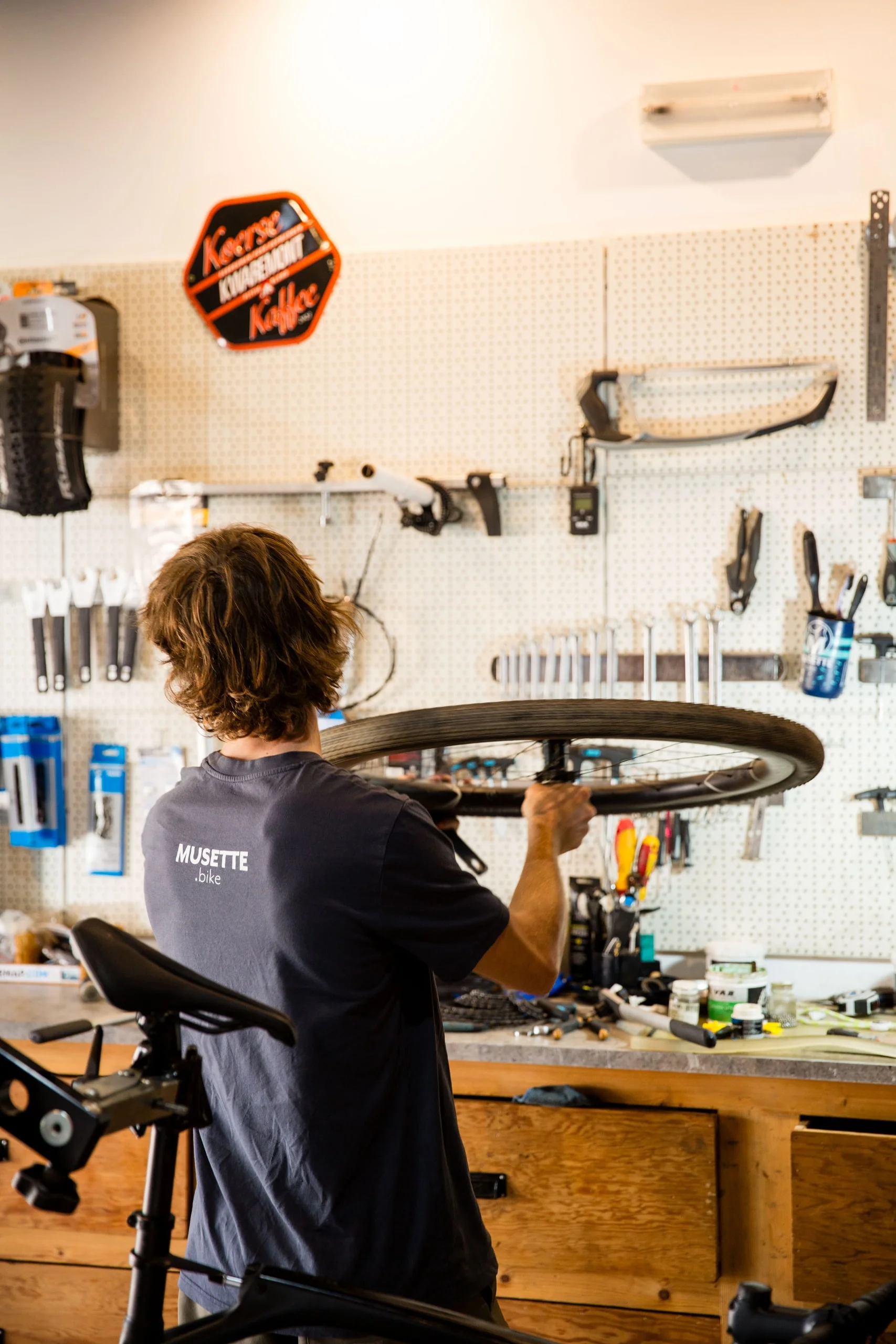 A mechanic truing a wheel in the Musette workshop in Almádena